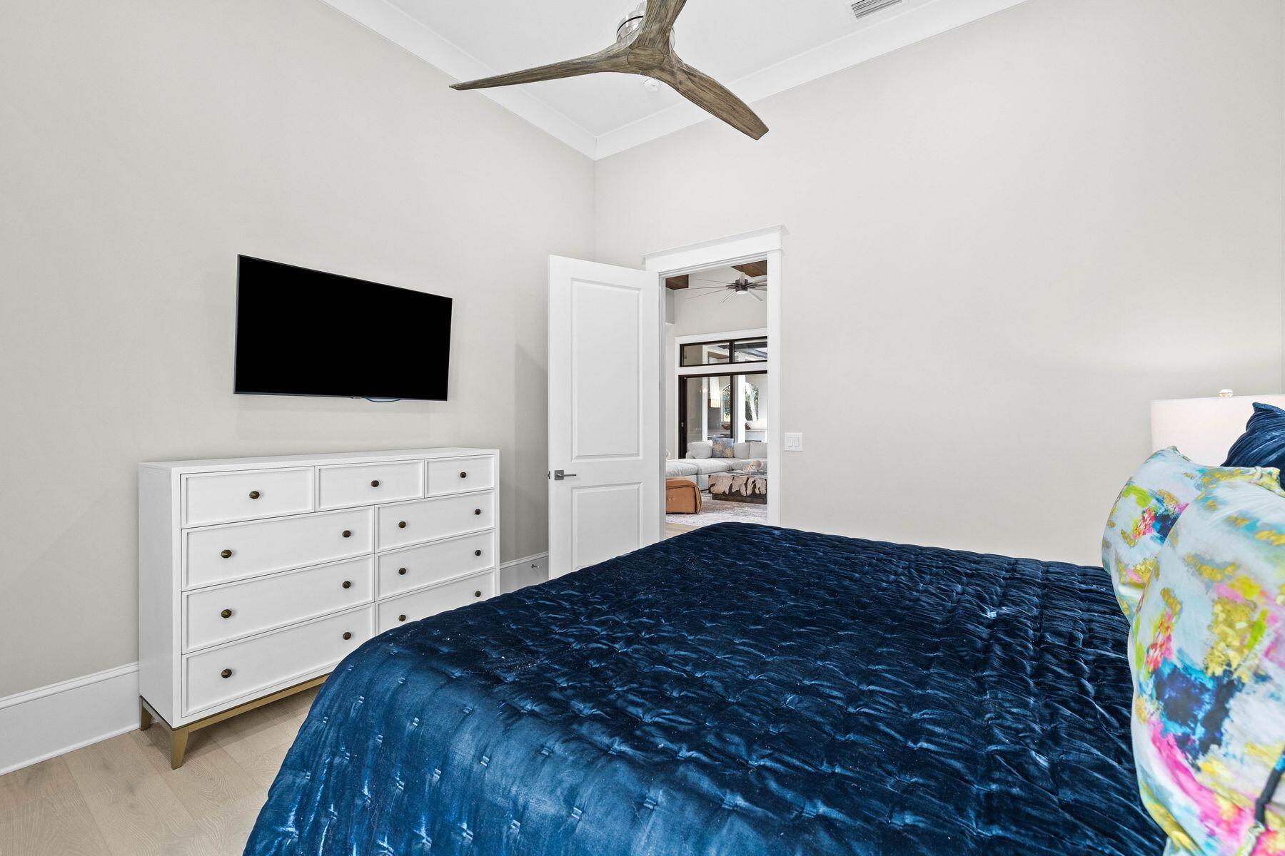 2939 Pine Valley Road Miramar Beach, FL 32550 - Photo 50 of 71 a bedroom with a bed and a flat tv screen on the dresser