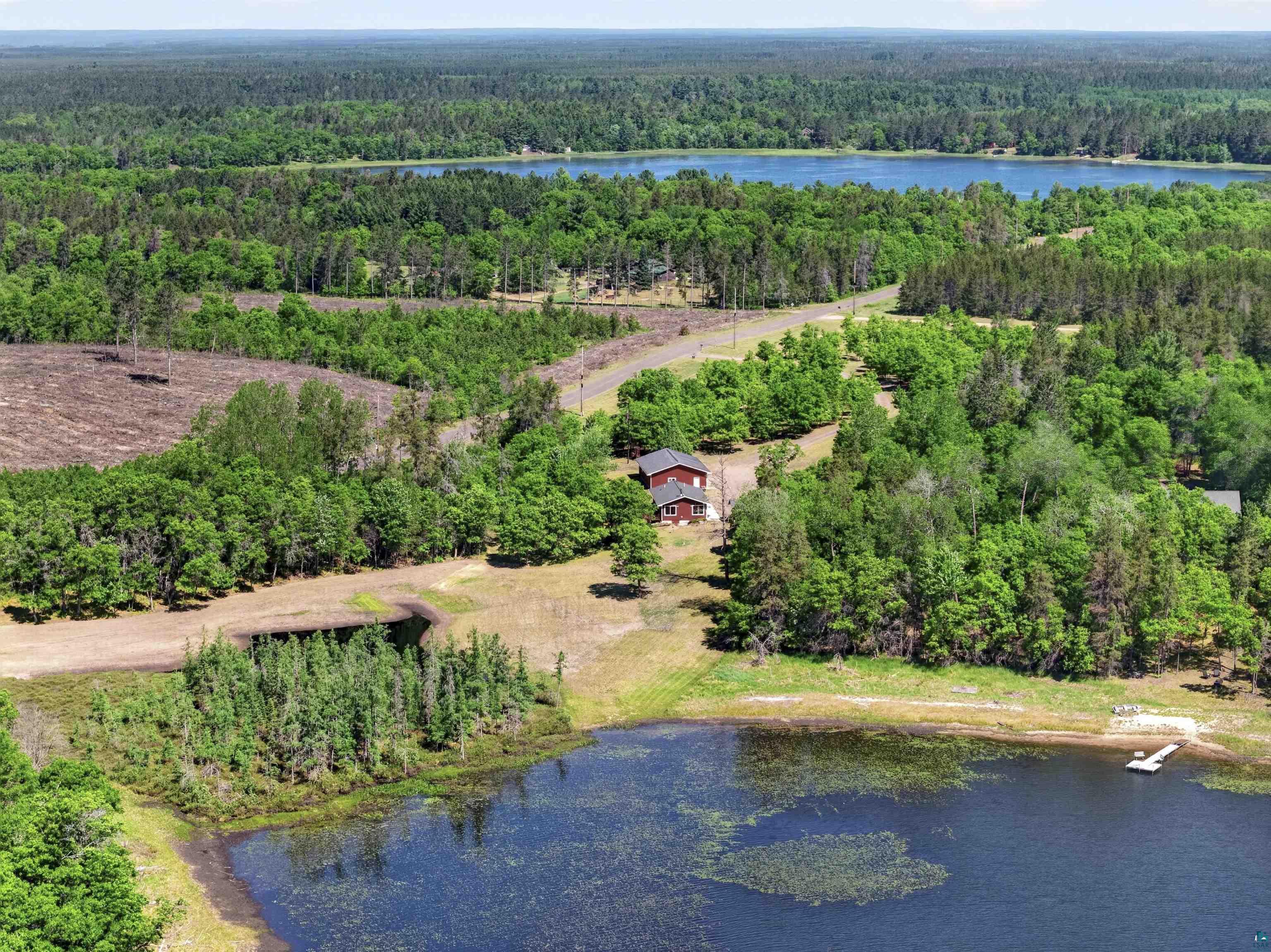 11702 East Mail Road Gordon, WI 54838 - Photo 3 of 60 Aerial perspective showcasing a red-sided structure nestled among extensive tree coverage