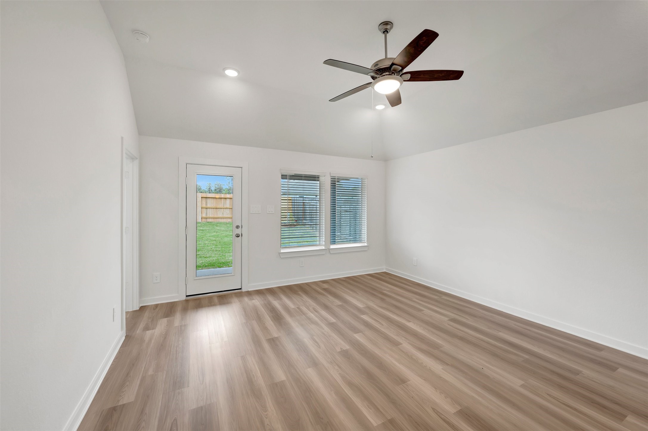 543 Flower Reed Court Magnolia, TX 77354 - Photo 3 of 46 a view of an empty room with wooden floor and a window