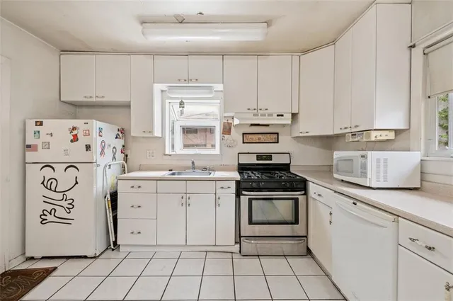a kitchen with granite countertop cabinets and appliances