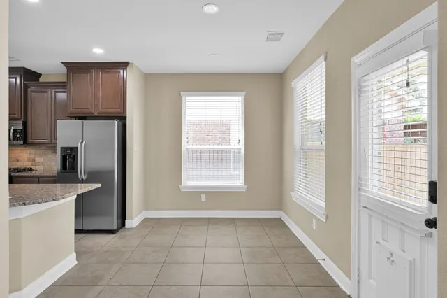a view of a kitchen with a sink dishwasher and a refrigerator