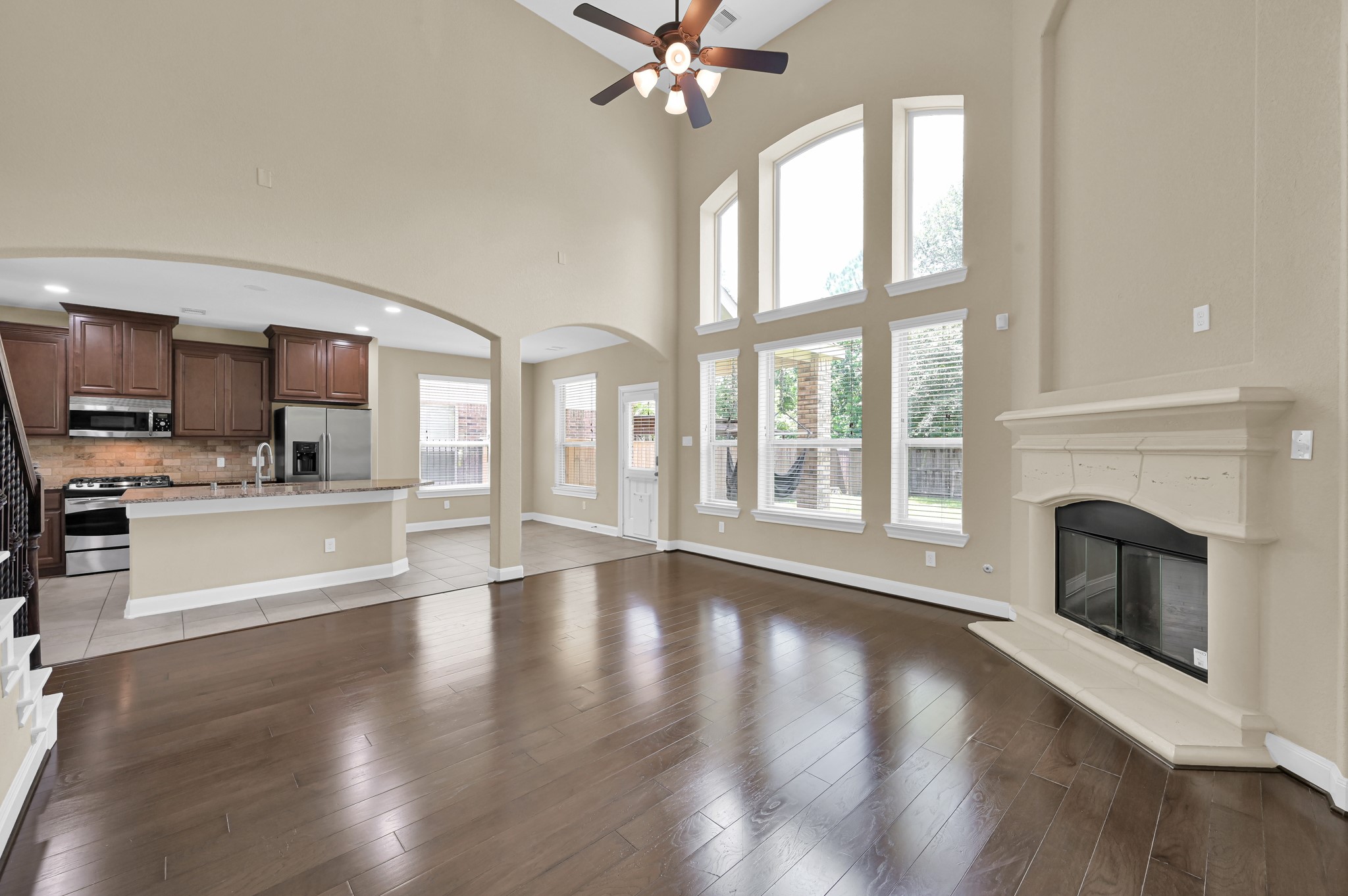 106 North Pinto Point Circle Spring, TX 77389 - Photo 13 of 39 a view of a kitchen with a stove cabinets a fireplace and wooden floor