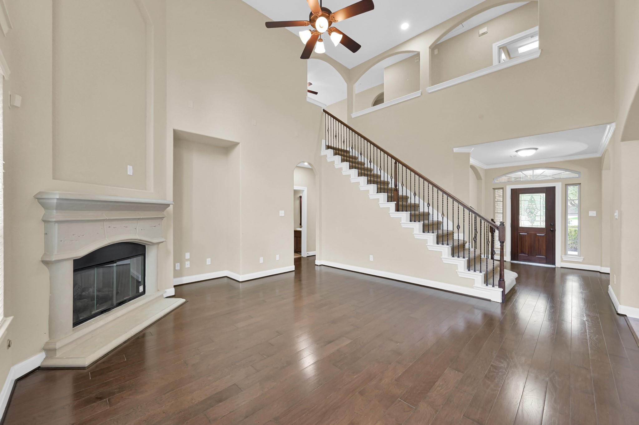 106 North Pinto Point Circle Spring, TX 77389 - Photo 15 of 39 a view of an empty room with wooden floor a fireplace and a window