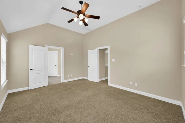 an empty room with a ceiling fan and closet