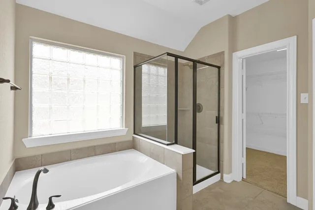 a bathroom with a bathtub and a shower