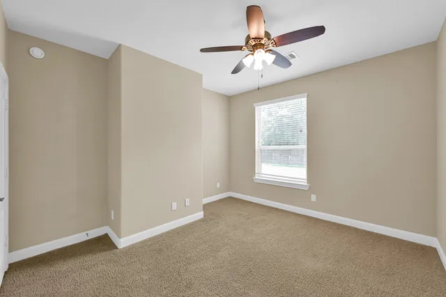 a view of room with window and ceiling fan
