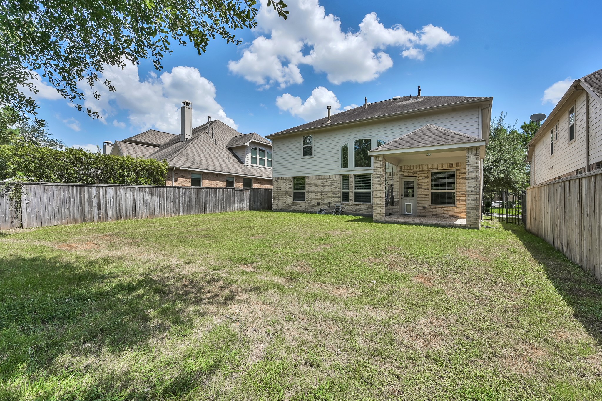 106 North Pinto Point Circle Spring, TX 77389 - Photo 37 of 39 a view of a house with a big yard and large tree