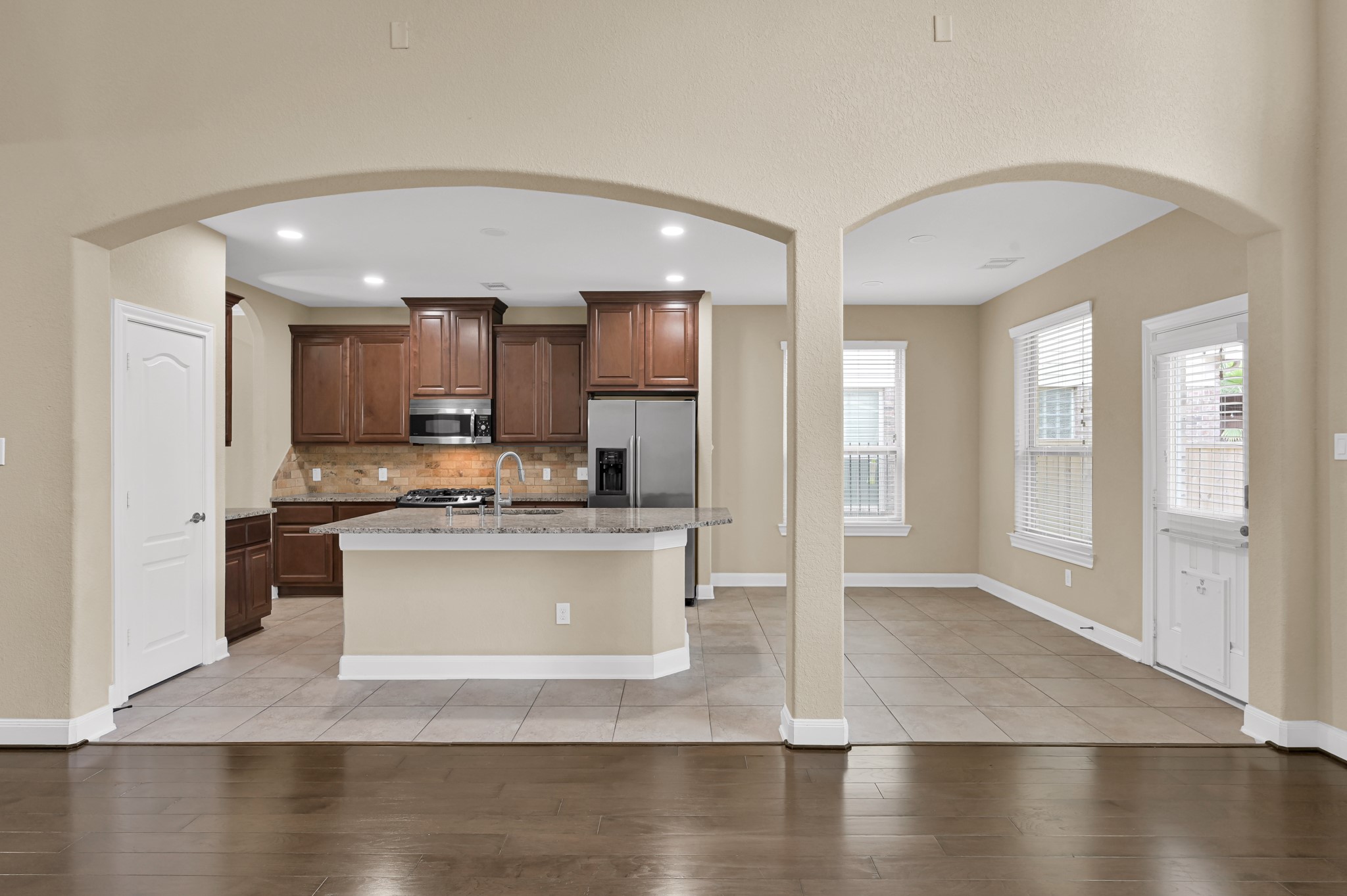 106 North Pinto Point Circle Spring, TX 77389 - Photo 7 of 39 a view of a kitchen with kitchen island a sink stainless steel appliances and cabinets