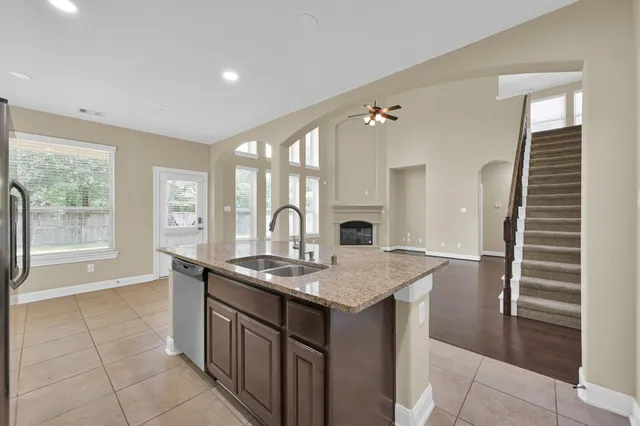 a kitchen with a sink a counter space and a window
