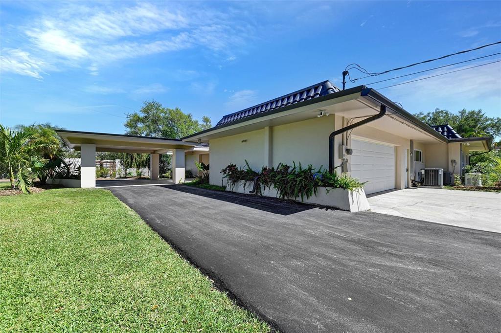 1875 Belleair Road Clearwater, FL 33764 - Photo 72 of 100 a front view of a house with a yard and potted plants