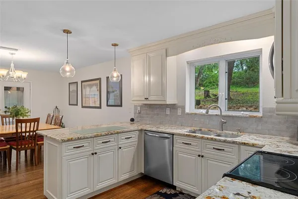 a kitchen with appliances cabinets and a window
