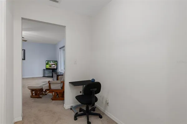 a spacious bathroom with a toilet a sink a glass door a shower a mirror a vanity and window