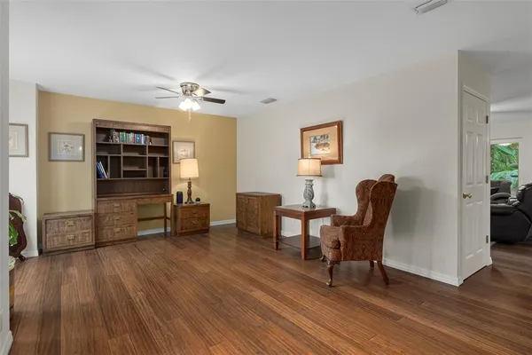 a view of a workspace with furniture and wooden floor