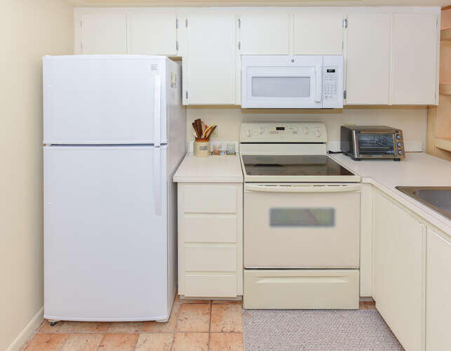 1605 Highway 1, Unit C203 Jupiter, FL 33477 - Photo 18 of 31 a kitchen with a refrigerator sink stove and cabinets