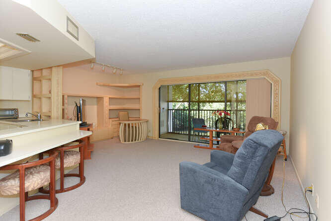 1605 Highway 1, Unit C203 Jupiter, FL 33477 - Photo 7 of 31 a living room with furniture and a large window