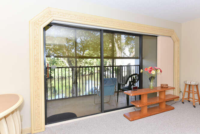 1605 Highway 1, Unit C203 Jupiter, FL 33477 - Photo 9 of 31 a living room with hardwood floor and a large window