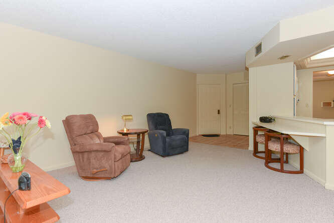 1605 Highway 1, Unit C203 Jupiter, FL 33477 - Photo 10 of 31 a living room with furniture and a table