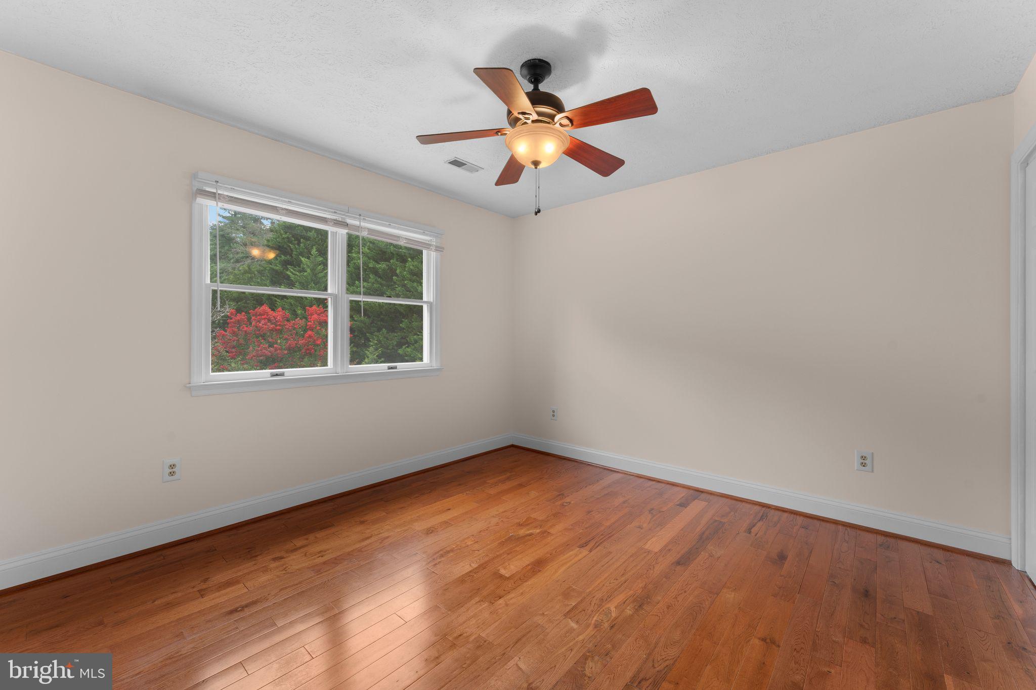 13360 Cameron Court Boston, VA 22713 - Photo 60 of 76 an empty room with ceiling fan and window