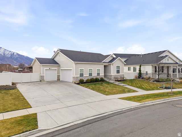 1159 South 700 West, Unit 38 Springville, UT 84663 - Photo 1 of 1 Ranch-style home featuring stone siding, concrete driveway, a gate, an attached garage, and roof with shingles