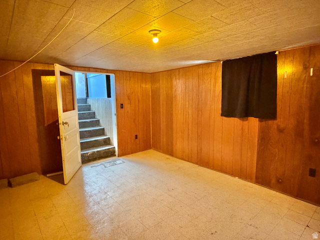 196 North 5th West Price, UT 84501 - Photo 19 of 27 Finished room featuring wood paneling, tiled flooring, and a drop ceiling