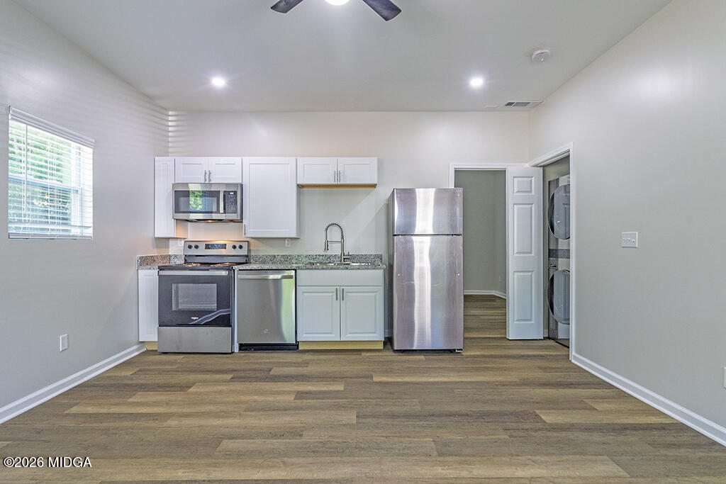 114 Emily Street Macon, GA 31204 - Photo 4 of 21 a kitchen with a refrigerator and a stove top oven