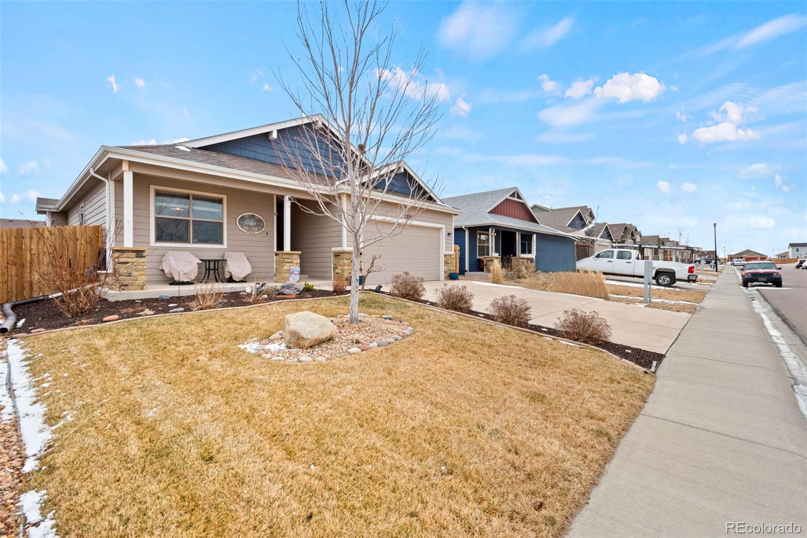 1109 Bison Way Wiggins, CO 80654 - Photo 1 of 33 a front view of house with yard outdoor seating and barbeque oven