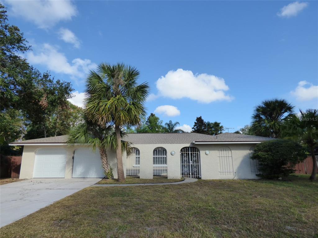 6895 Tamarind Circle Orlando, FL 32819 - Photo 1 of 1 a view of a yard in front of a house with a garage