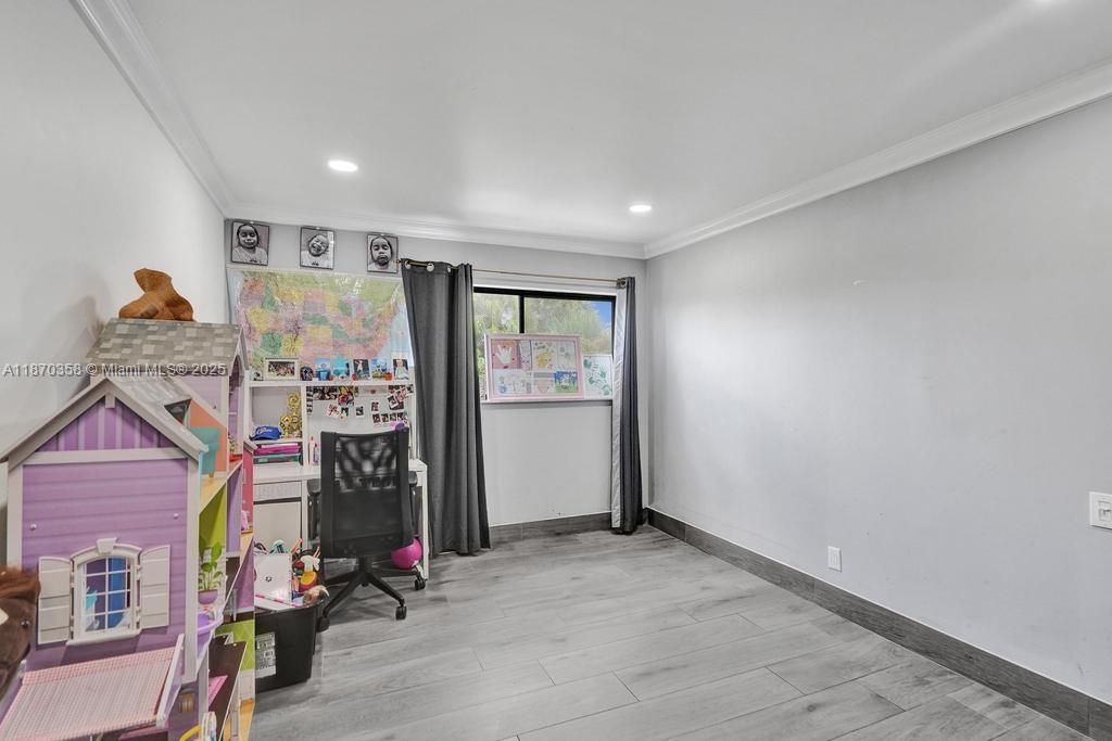 900 Crystal Lake Drive, Unit 2B Deerfield Beach, FL 33073 - Photo 17 of 41 a view of a room with gym equipment