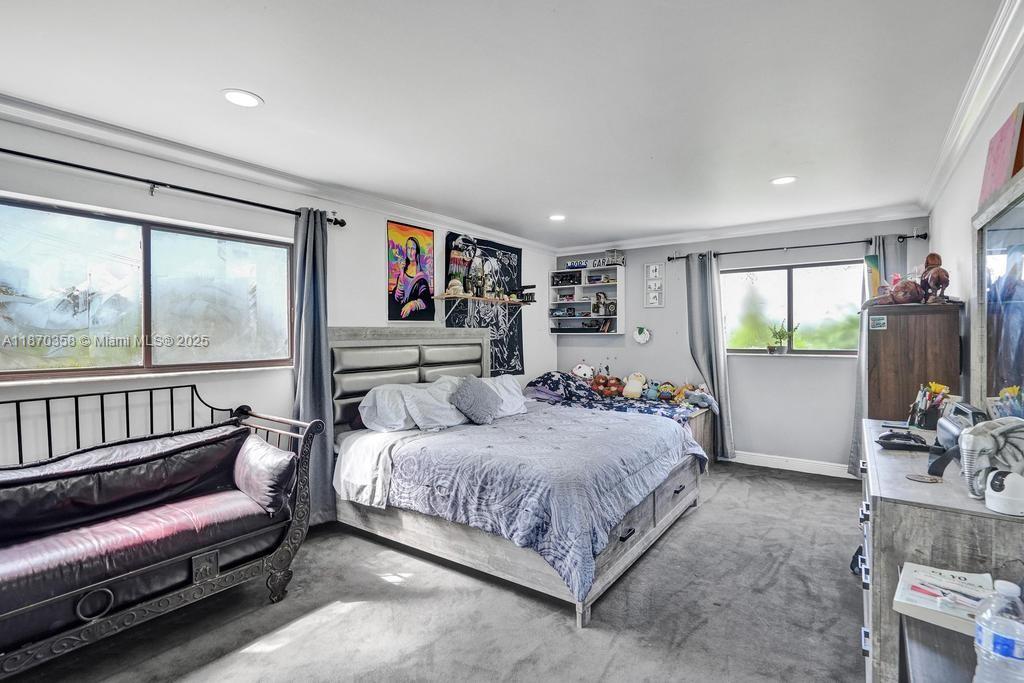 900 Crystal Lake Drive, Unit 2B Deerfield Beach, FL 33073 - Photo 23 of 41 a bedroom with a bed and a large window