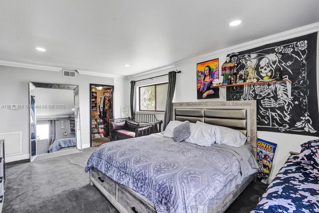 900 Crystal Lake Drive, Unit 2B Deerfield Beach, FL 33073 - Photo 25 of 41 a bedroom with a large bed and a large mirror