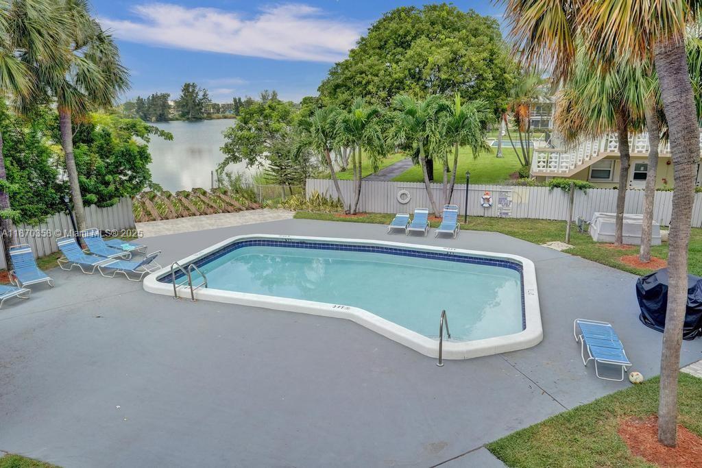 900 Crystal Lake Drive, Unit 2B Deerfield Beach, FL 33073 - Photo 30 of 41 a view of a backyard with palm trees