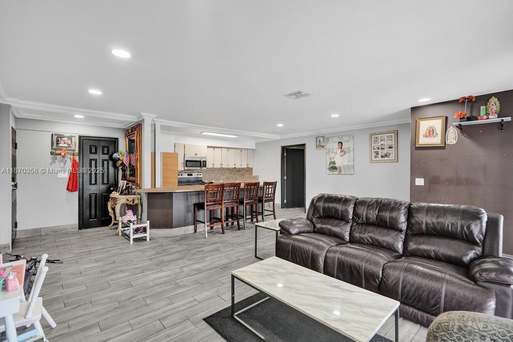 900 Crystal Lake Drive, Unit 2B Deerfield Beach, FL 33073 - Photo 3 of 41 a living room with furniture and a wooden floor