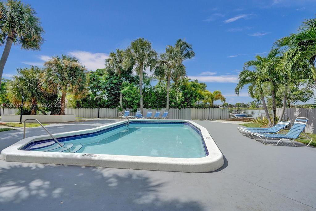 900 Crystal Lake Drive, Unit 2B Deerfield Beach, FL 33073 - Photo 32 of 41 a view of a swimming pool with a patio