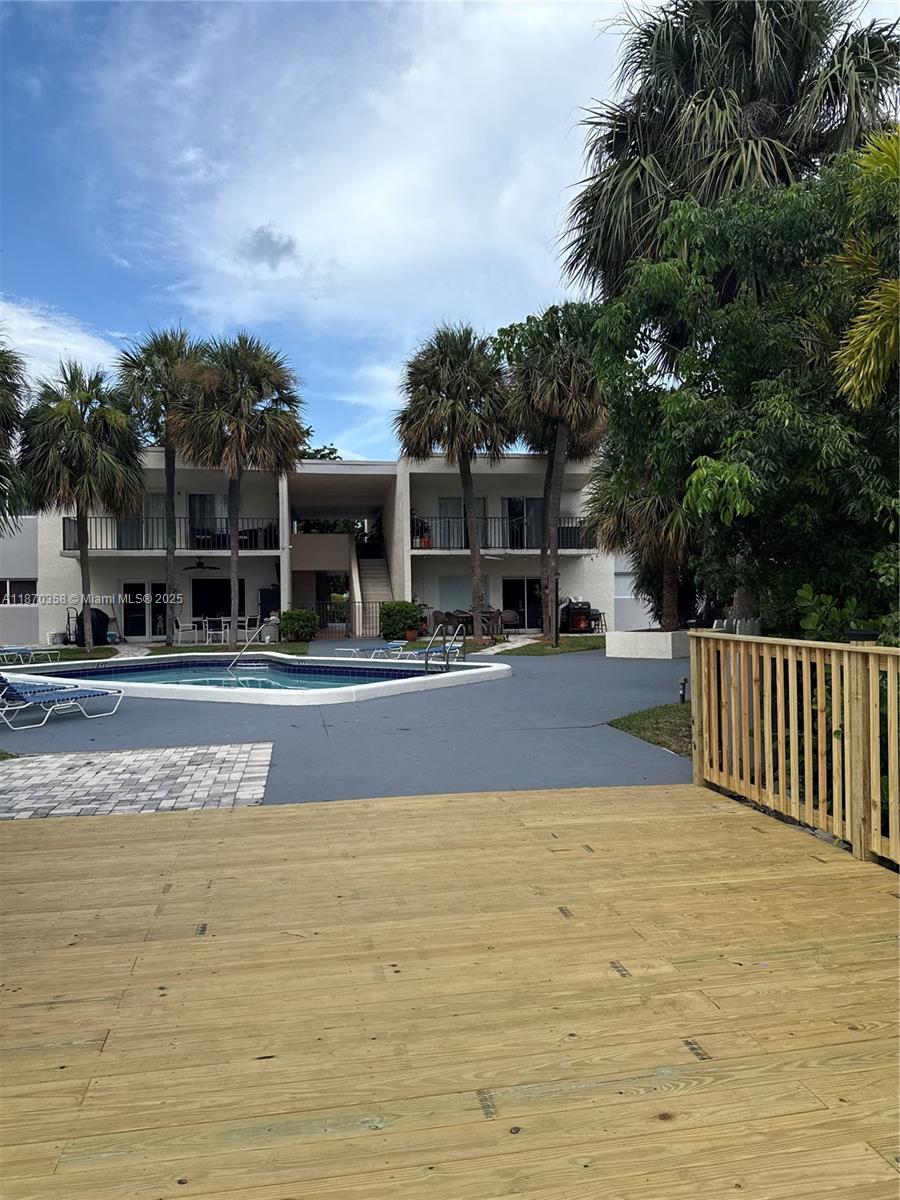 900 Crystal Lake Drive, Unit 2B Deerfield Beach, FL 33073 - Photo 35 of 41 a view of swimming pool with outdoor seating and plants