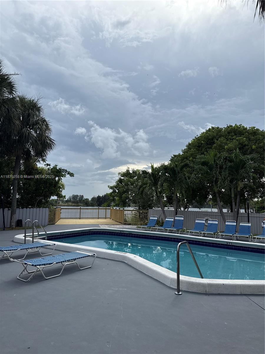 900 Crystal Lake Drive, Unit 2B Deerfield Beach, FL 33073 - Photo 37 of 41 a view of swimming pool with outdoor seating and plants