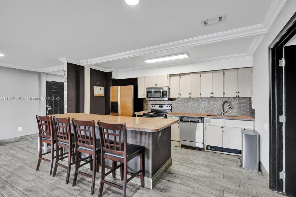 900 Crystal Lake Drive, Unit 2B Deerfield Beach, FL 33073 - Photo 6 of 41 a view of a dining room with furniture and wooden floor