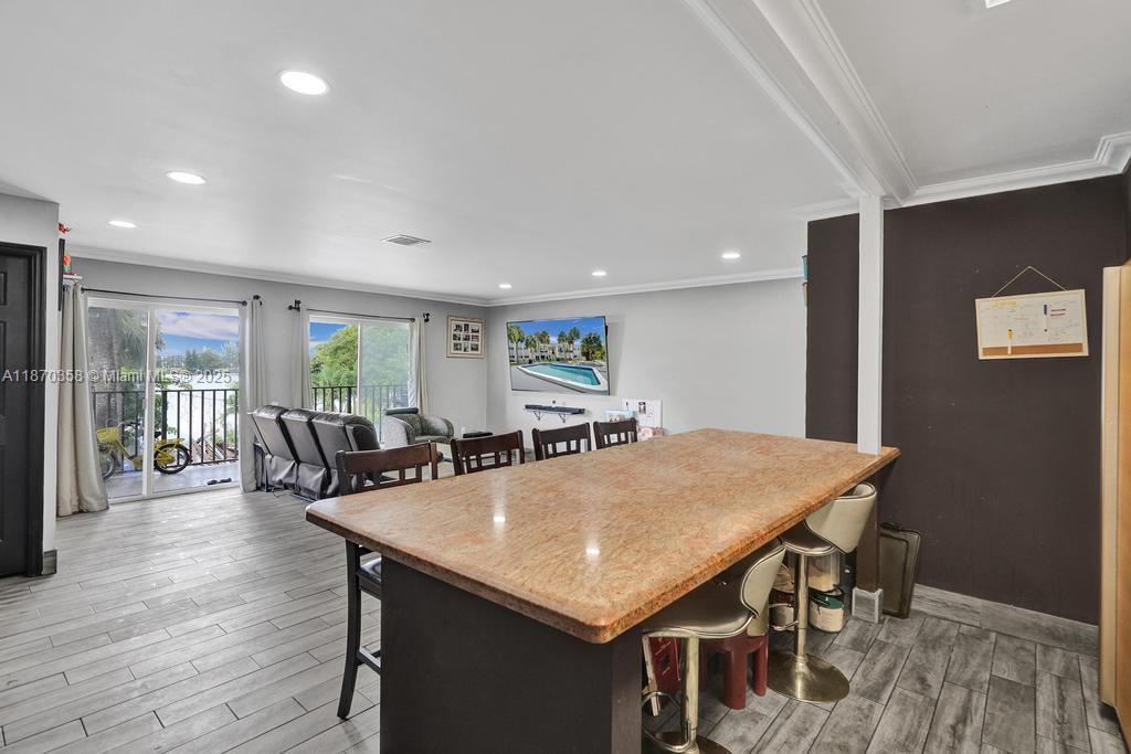 900 Crystal Lake Drive, Unit 2B Deerfield Beach, FL 33073 - Photo 9 of 41 a view of a dining room with furniture and wooden floor