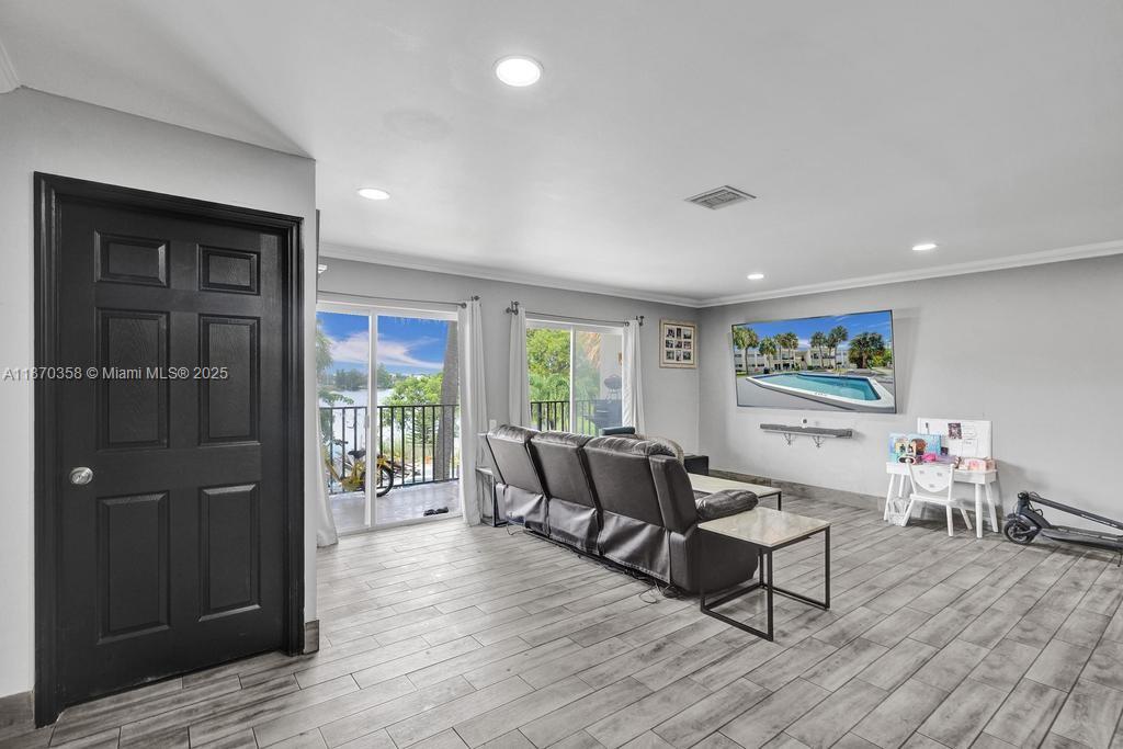 900 Crystal Lake Drive, Unit 2B Deerfield Beach, FL 33073 - Photo 10 of 41 a living room with furniture and a wooden floor