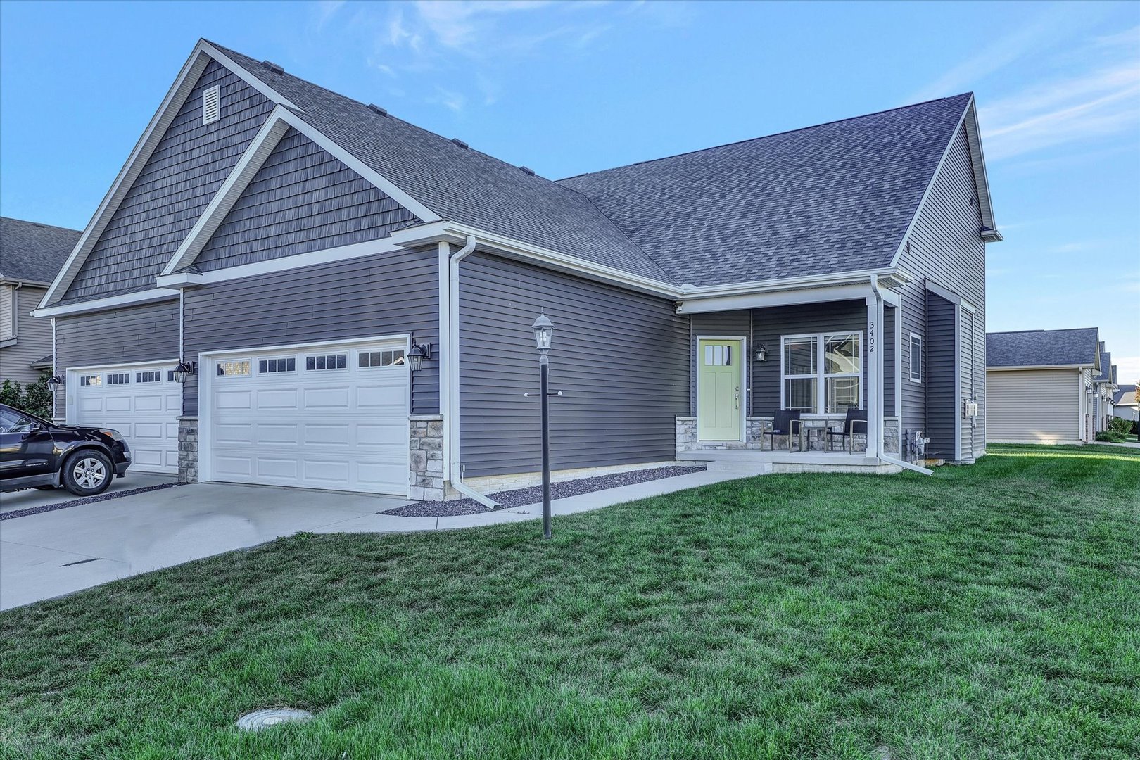 3402 Boulder Ridge Drive Champaign, IL 61822 - Photo 1 of 42 a front view of a house with a yard and garage
