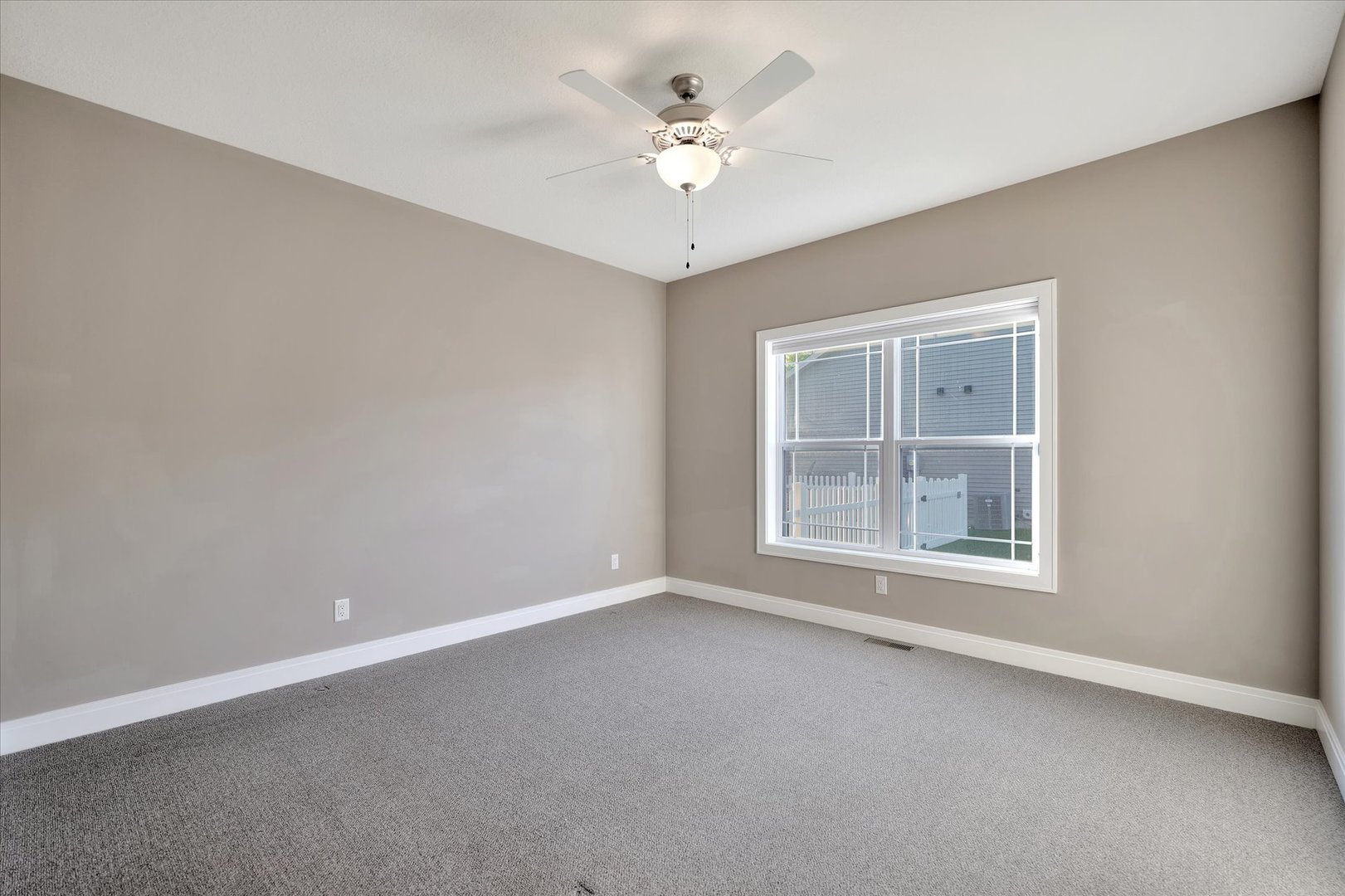 3402 Boulder Ridge Drive Champaign, IL 61822 - Photo 14 of 42 an empty room with a chandelier fan and windows