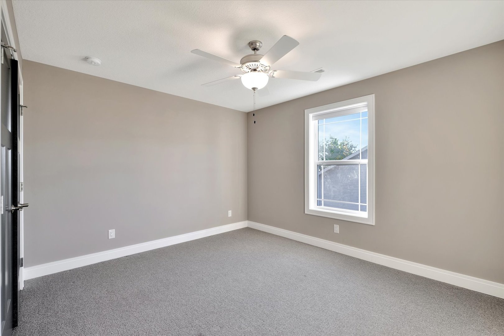 3402 Boulder Ridge Drive Champaign, IL 61822 - Photo 25 of 42 an empty room with a window and a fan