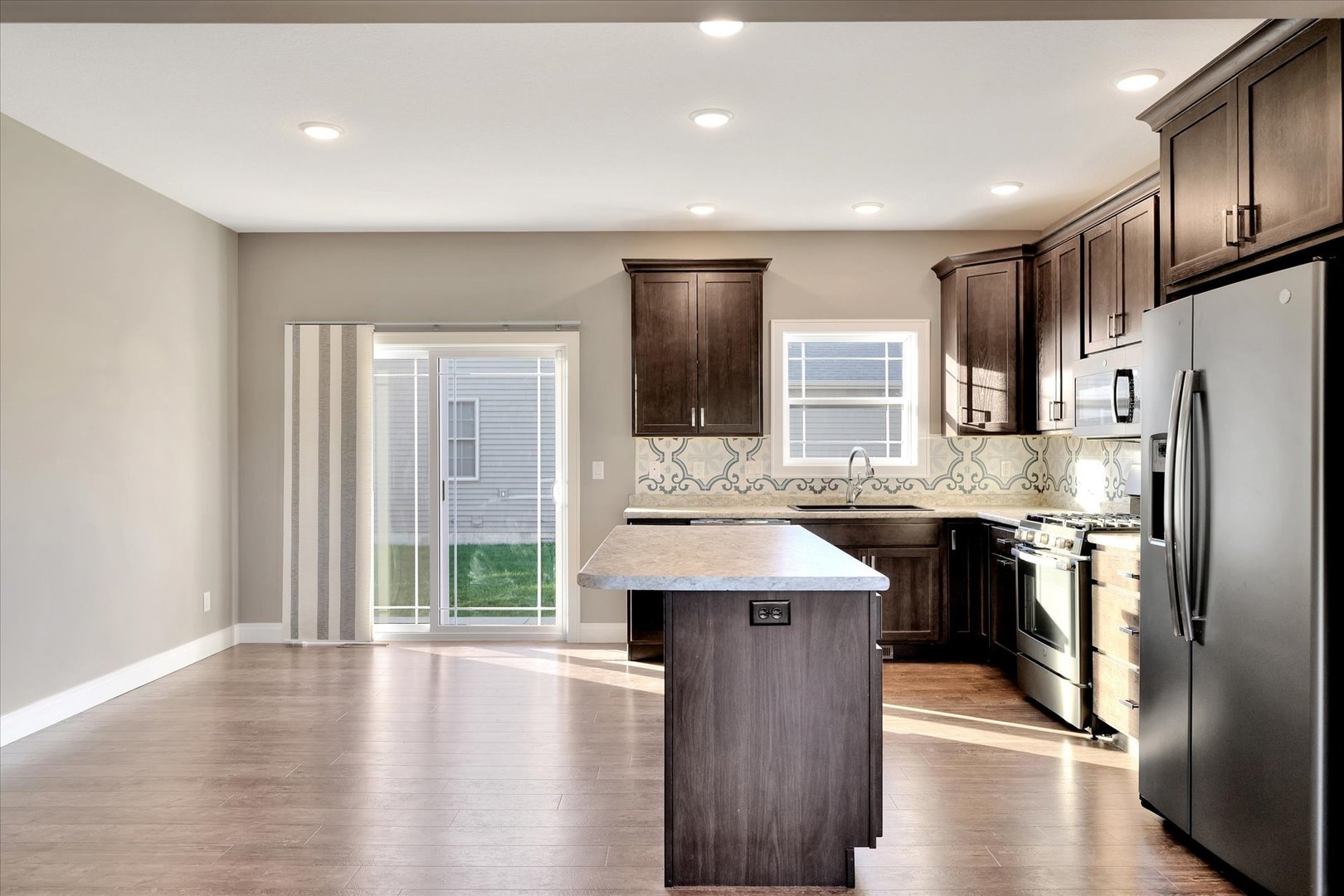 3402 Boulder Ridge Drive Champaign, IL 61822 - Photo 8 of 42 a kitchen with stainless steel appliances granite countertop a refrigerator a sink dishwasher a stove and a oven with wooden floor