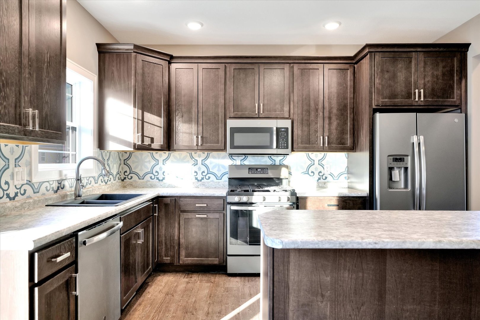 3402 Boulder Ridge Drive Champaign, IL 61822 - Photo 9 of 42 a kitchen with kitchen island granite countertop a sink stove and refrigerator