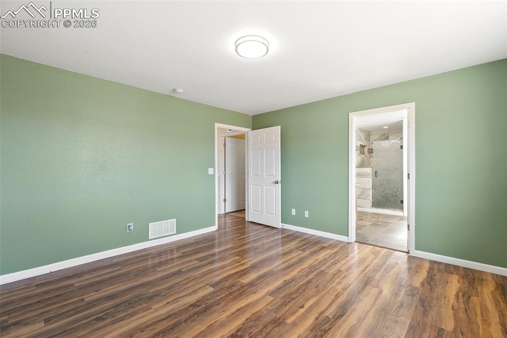 7678 Dutch Loop Colorado Springs, CO 80925 - Photo 14 of 29 a view of empty room with wooden floor