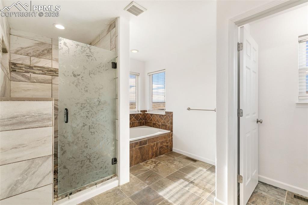 7678 Dutch Loop Colorado Springs, CO 80925 - Photo 15 of 29 a bathroom with a sink and shower