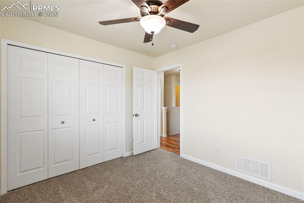 7678 Dutch Loop Colorado Springs, CO 80925 - Photo 19 of 29 a view of an empty room and a ceiling fan