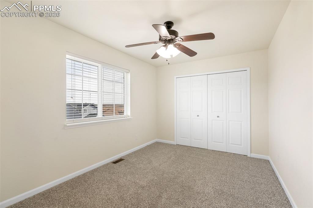7678 Dutch Loop Colorado Springs, CO 80925 - Photo 20 of 29 a view of an empty room with a window