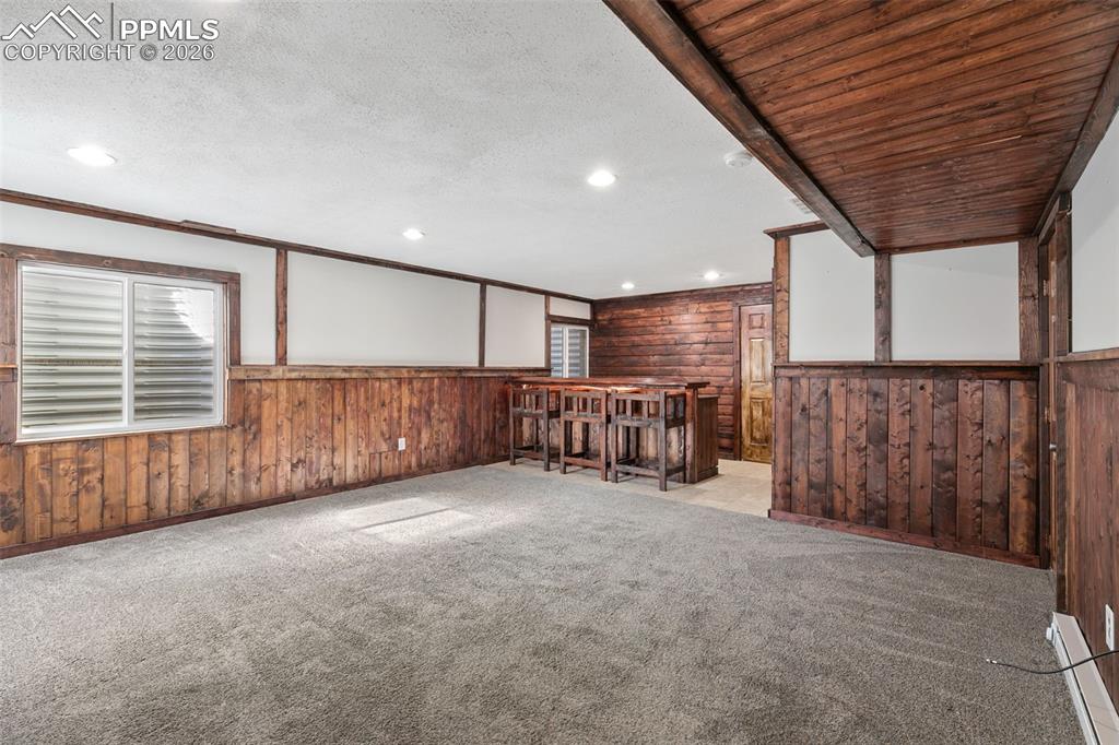 7678 Dutch Loop Colorado Springs, CO 80925 - Photo 23 of 29 a view of an empty room with wooden walls