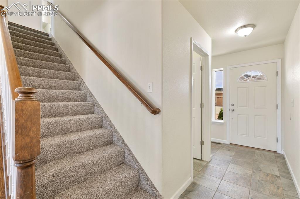 7678 Dutch Loop Colorado Springs, CO 80925 - Photo 3 of 29 a view of an entryway with staircase