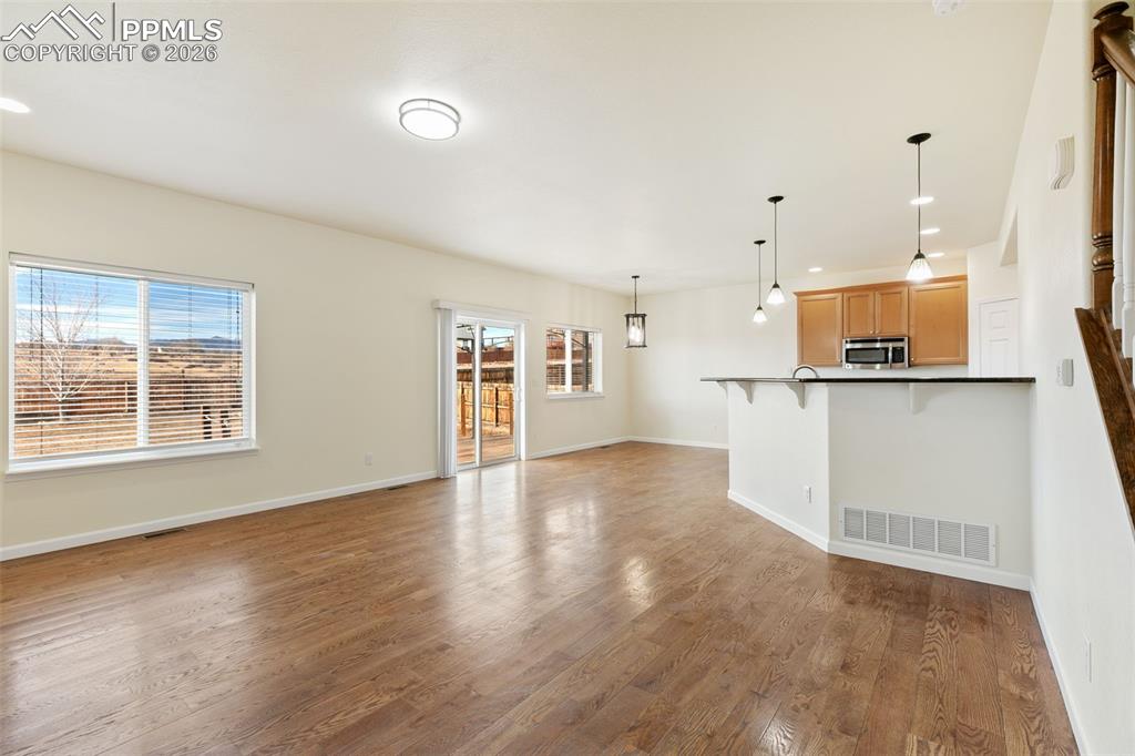 7678 Dutch Loop Colorado Springs, CO 80925 - Photo 5 of 29 a view of large kitchen with wooden floor and electronic appliances